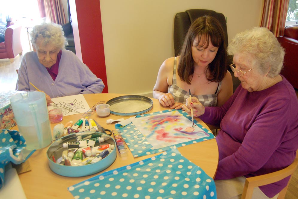Nurse and residents painting